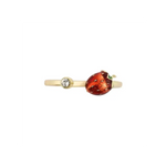 A gold-plated open bypass ring by Bill Skinner featuring a realistic 3D strawberry hand-painted with glossy red enamel and gold seeds, balanced by a bezel-set clear crystal. strawberry-enamel-ring.webp